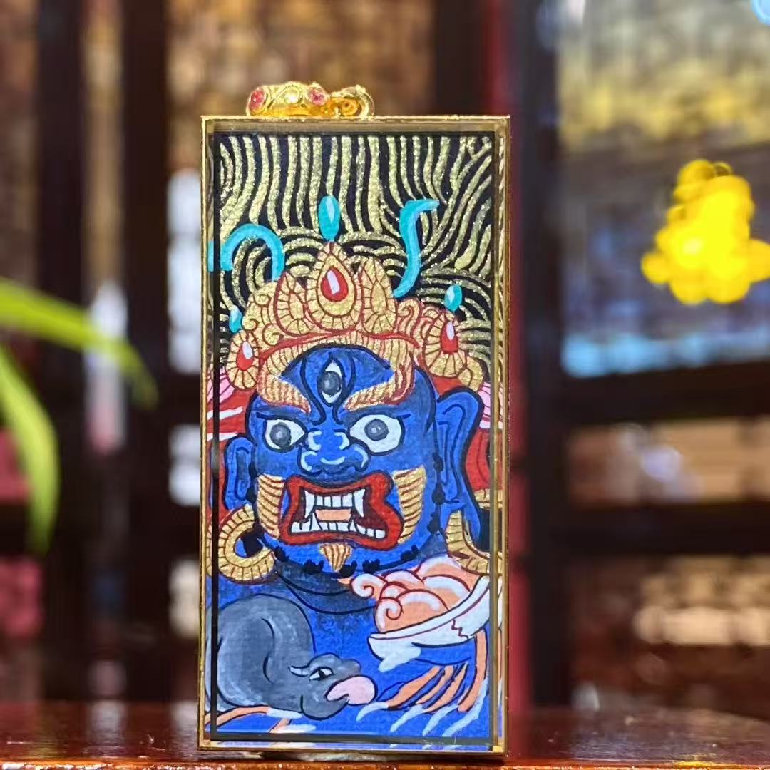 Front view of Black Jambhala thangka pendant, fully hand-painted on both sides with 18K gold, Rebgong Tibetan art, sapphire crystal Gawu box