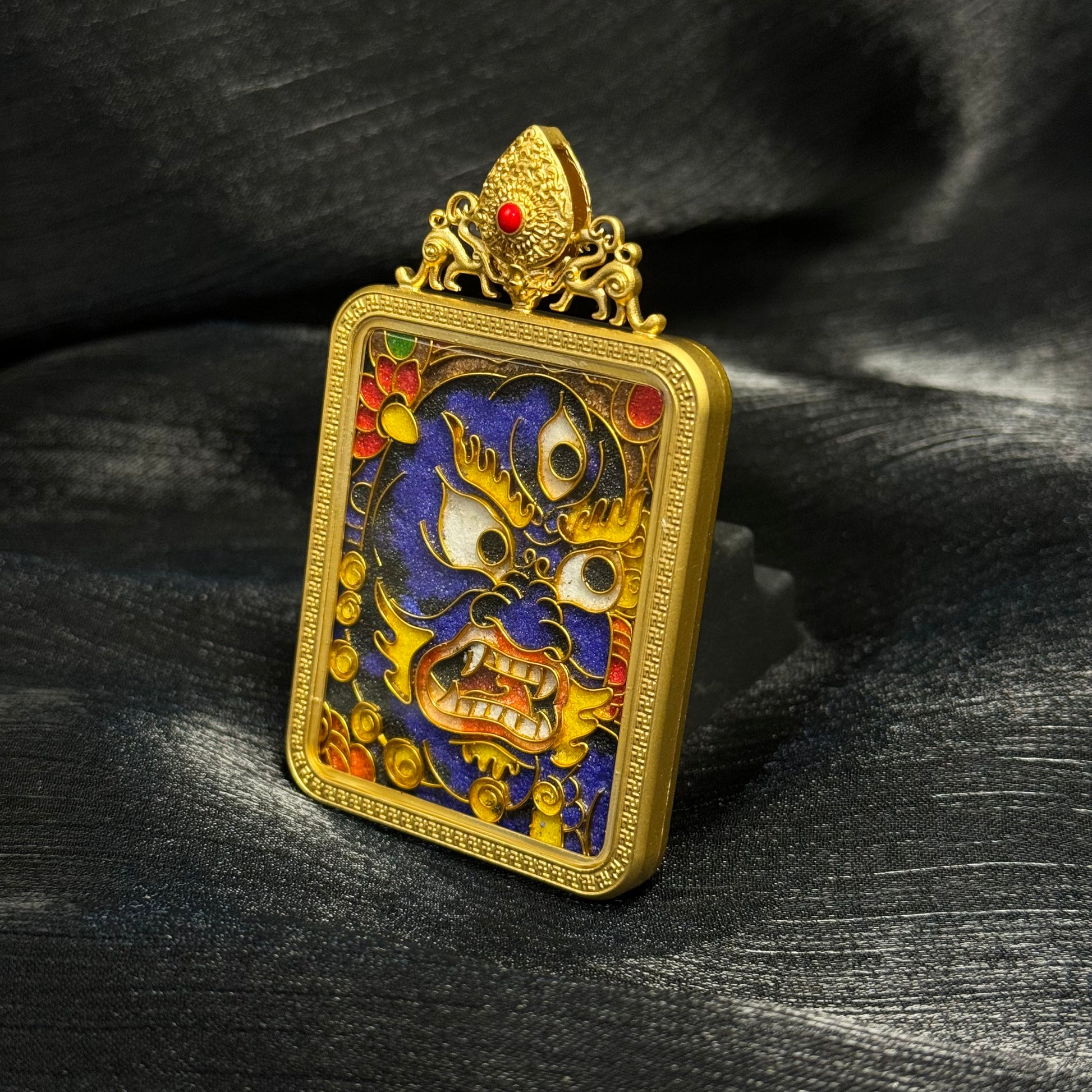 Full display of Black Jambhala cloisonné enamel mini thangka pendant with decorative gold-plated top ornament and traditional Tibetan wealth deity imagery