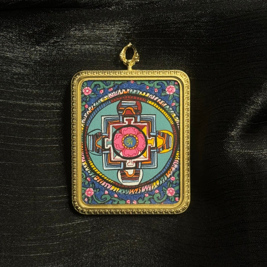 Detailed front view of mandala mini thangka pendant highlighting layered mineral pigment colors and sacred Buddhist geometric composition