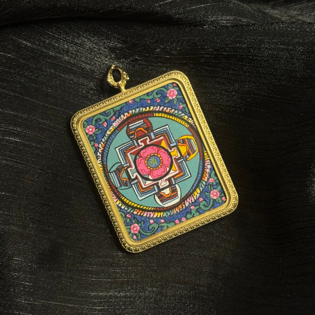Angled view of hand-painted Buddhist mandala mini thangka pendant featuring colorful geometric mandala artwork mounted in a titanium steel pendant frame