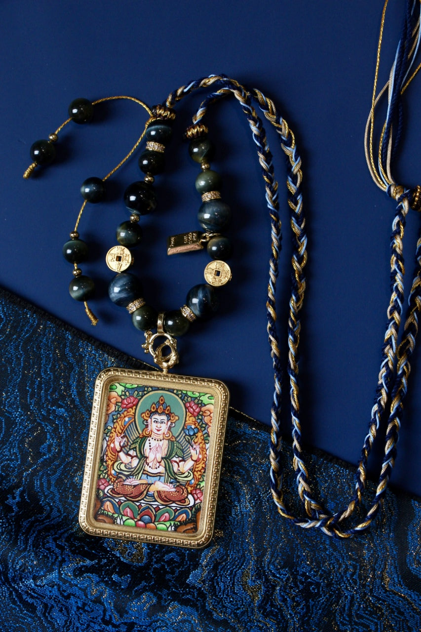 Full view of Four-Armed Avalokiteshvara mini thangka pendant necklace with braided cord, bead details, and gold-tone setting