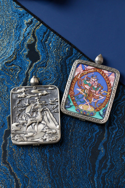 Set view of Chitipati (Cemetery Lord) miniature thangka pendant in a silver case, hand-painted with natural mineral pigments, Regong style.