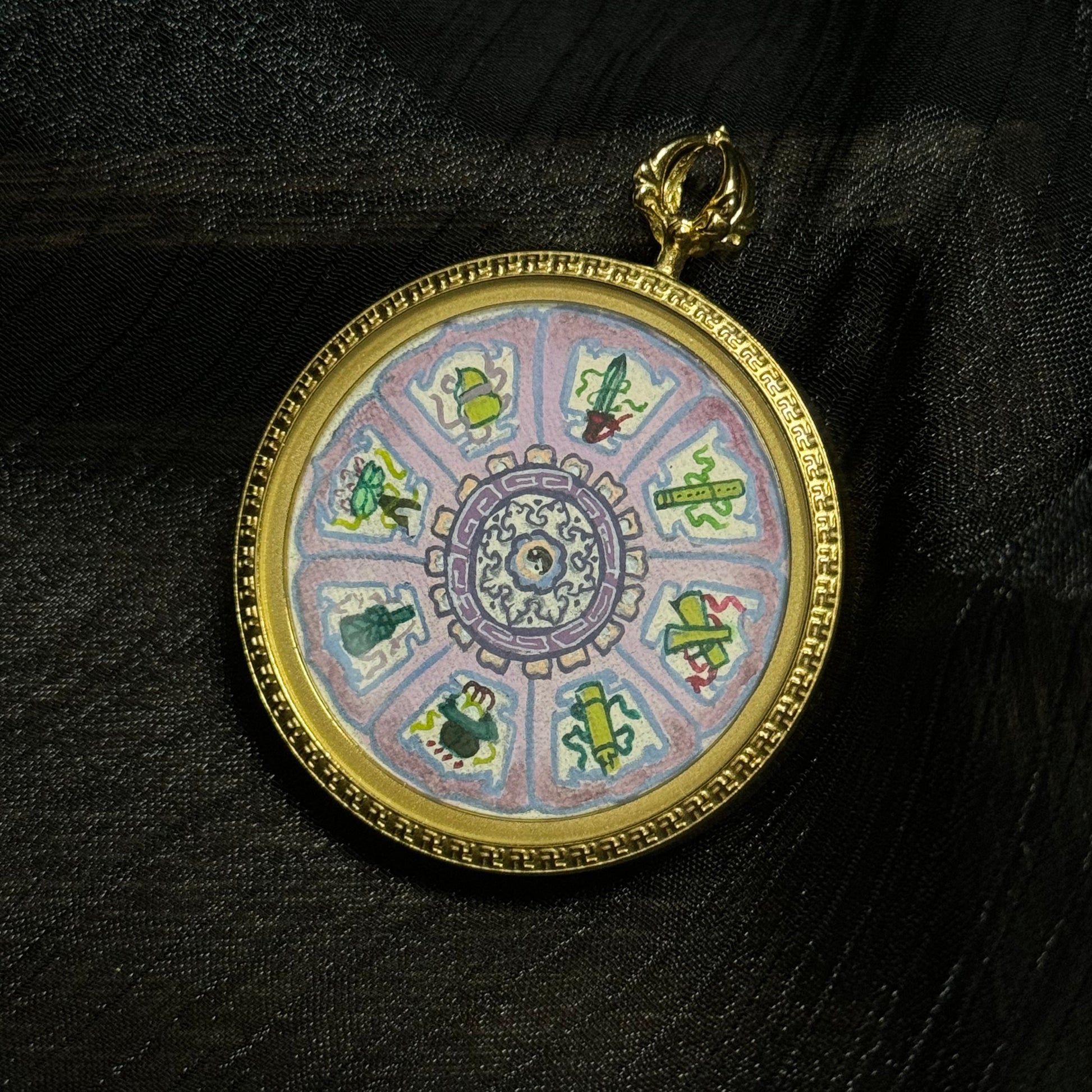 Close-up of Eight Immortals sacred symbols mini thangka pendant showing detailed hand-painted objects arranged in a circular mandala pattern.