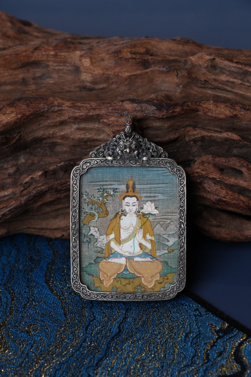 Close-up of Mahasthamaprapta Bodhisattva mini thangka pendant, fully hand-painted with mineral pigments, set in a vintage silver gawu case