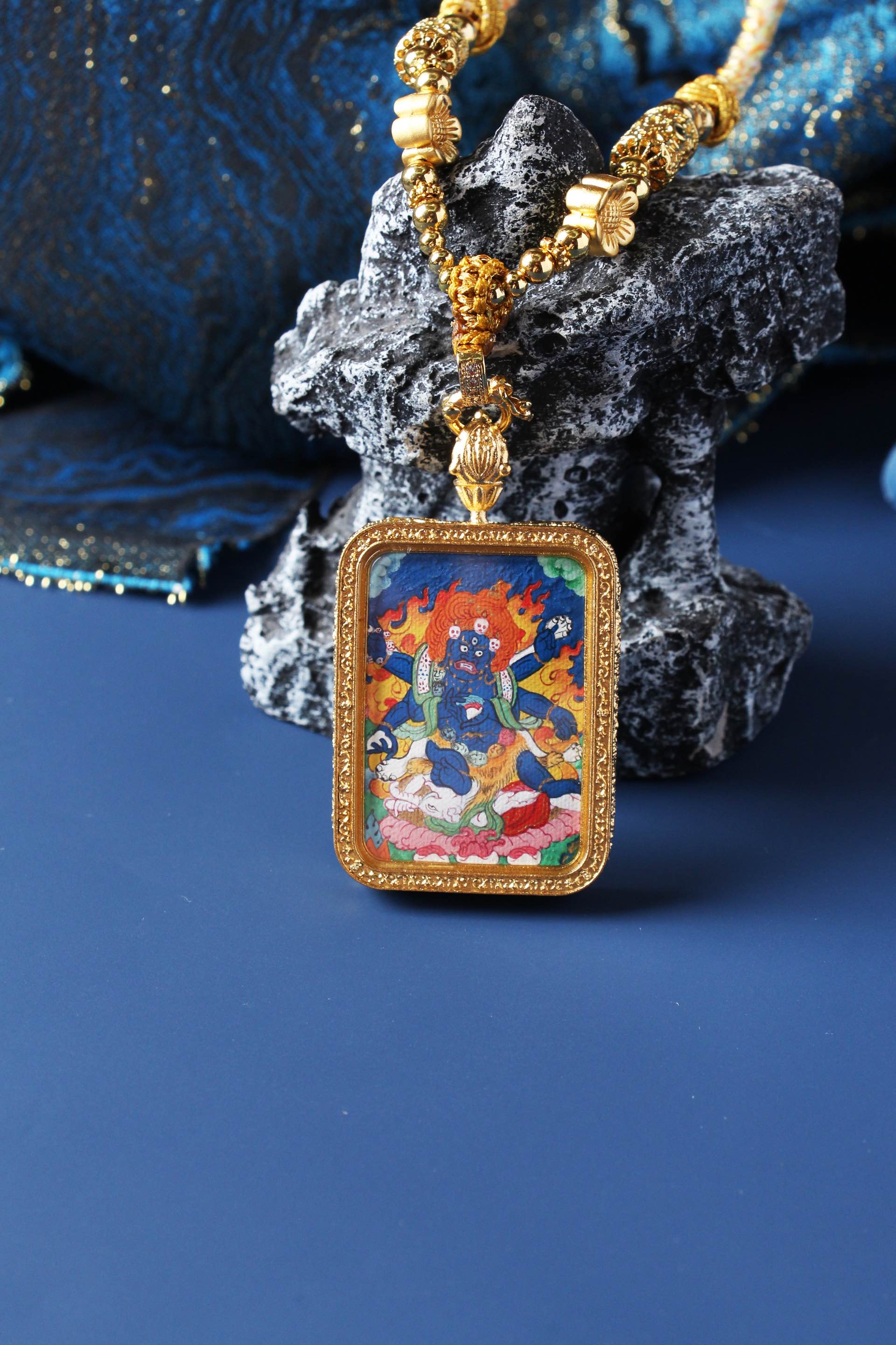 Close-up of Six-Armed Mahakala mini thangka pendant highlighting brushwork, mineral pigment color, and double-sided titanium steel case
