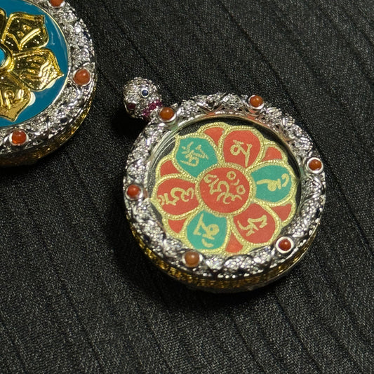 Close-up detail of the Avalokiteshvara Mani mantra miniature thangka showing gold powder Tibetan calligraphy on lotus petals painted with natural mineral pigments.