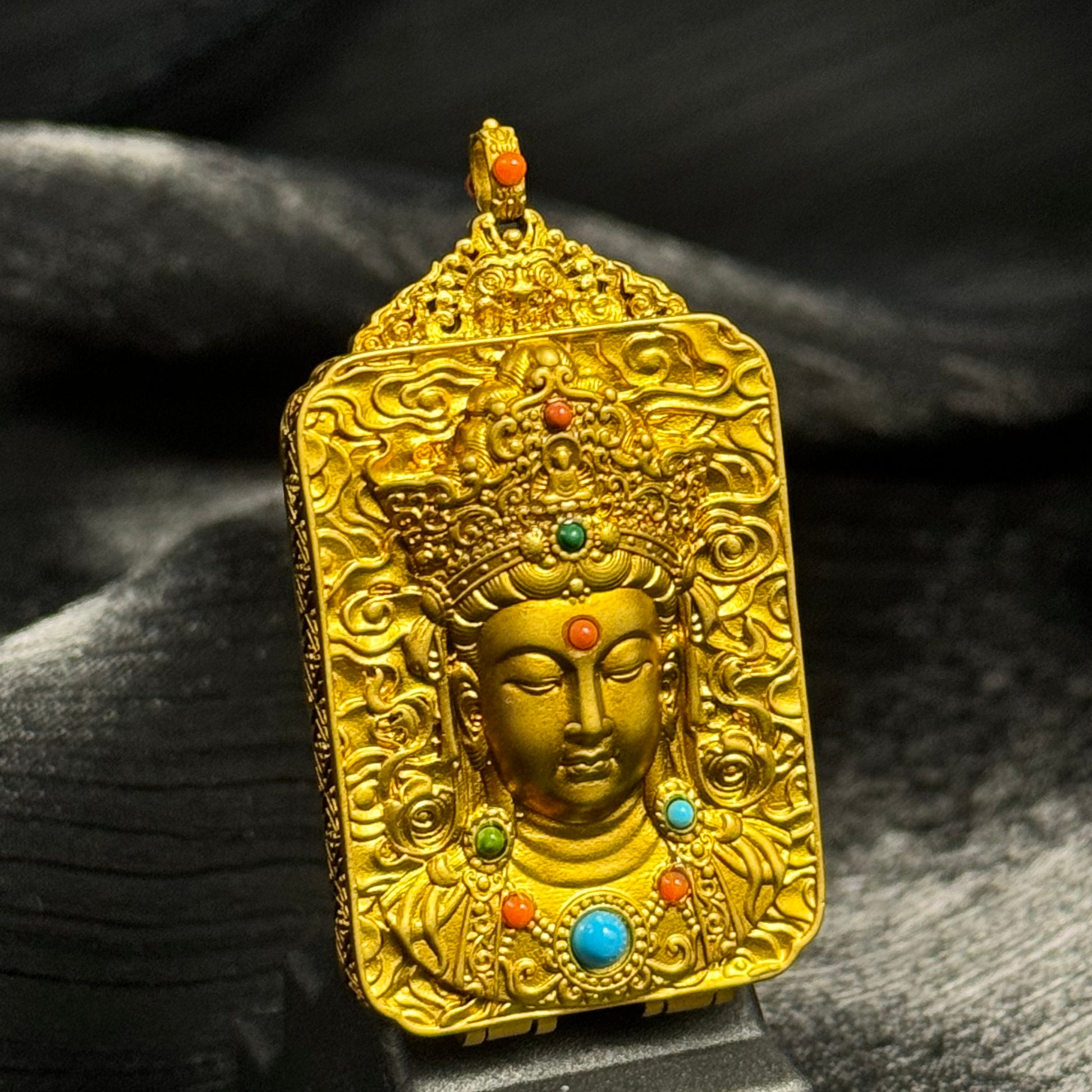 Back view of Tibetan copper gawu-style pendant featuring embossed bodhisattva relief and ornamental gemstone details