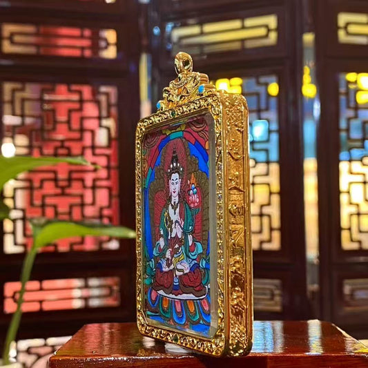 Side view of gold-plated copper Tibetan Gawu box containing a double-sided hand-painted Akashagarbha Bodhisattva and mandala thangka