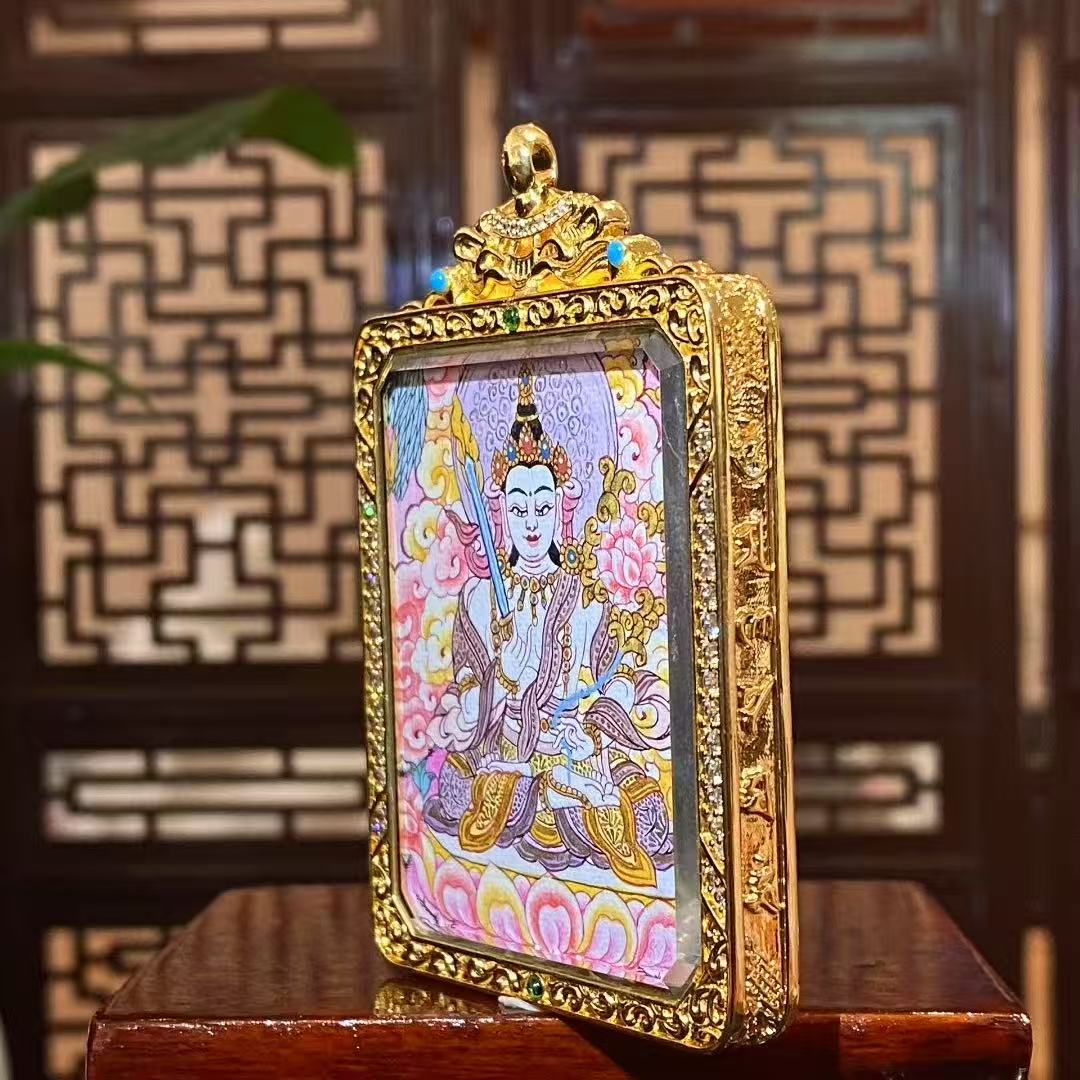 Side view of gold-plated copper Tibetan Gawu box containing a double-sided hand-painted Akashagarbha Bodhisattva and Four-Directional Mandala thangka