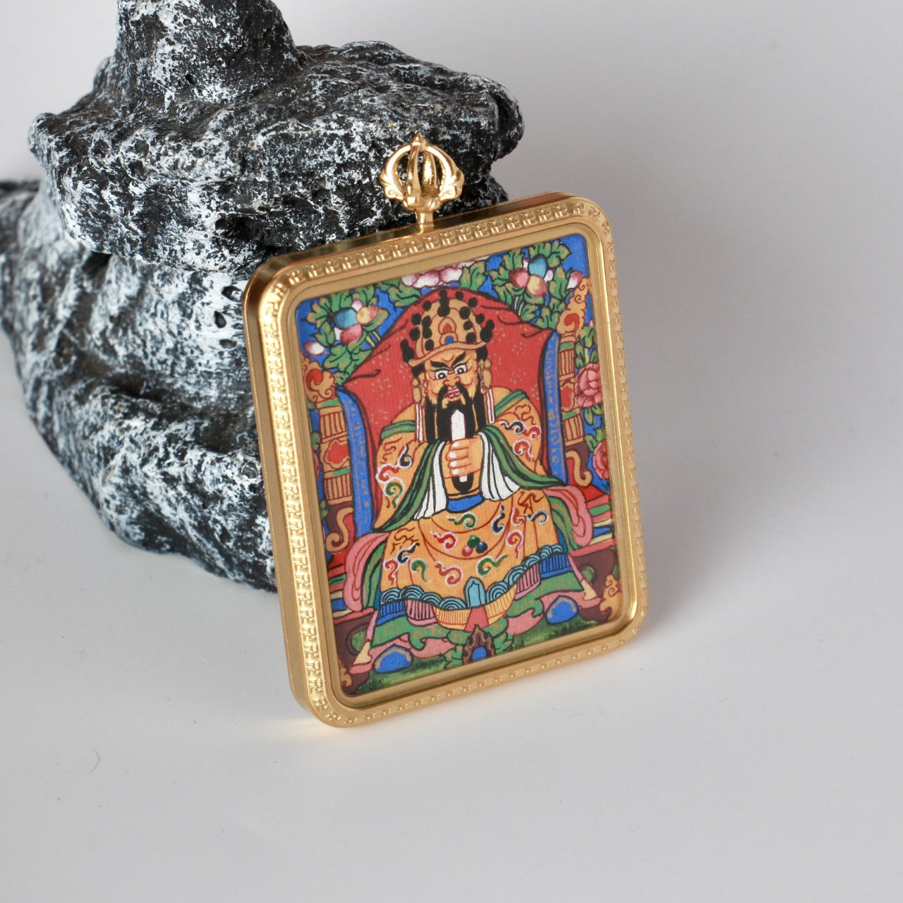 Front close-up of Dragon Fifth Lord mini thangka pendant highlighting the gold-tone titanium steel frame, fine border pattern, and vajra-style bail above the hand-painted image.