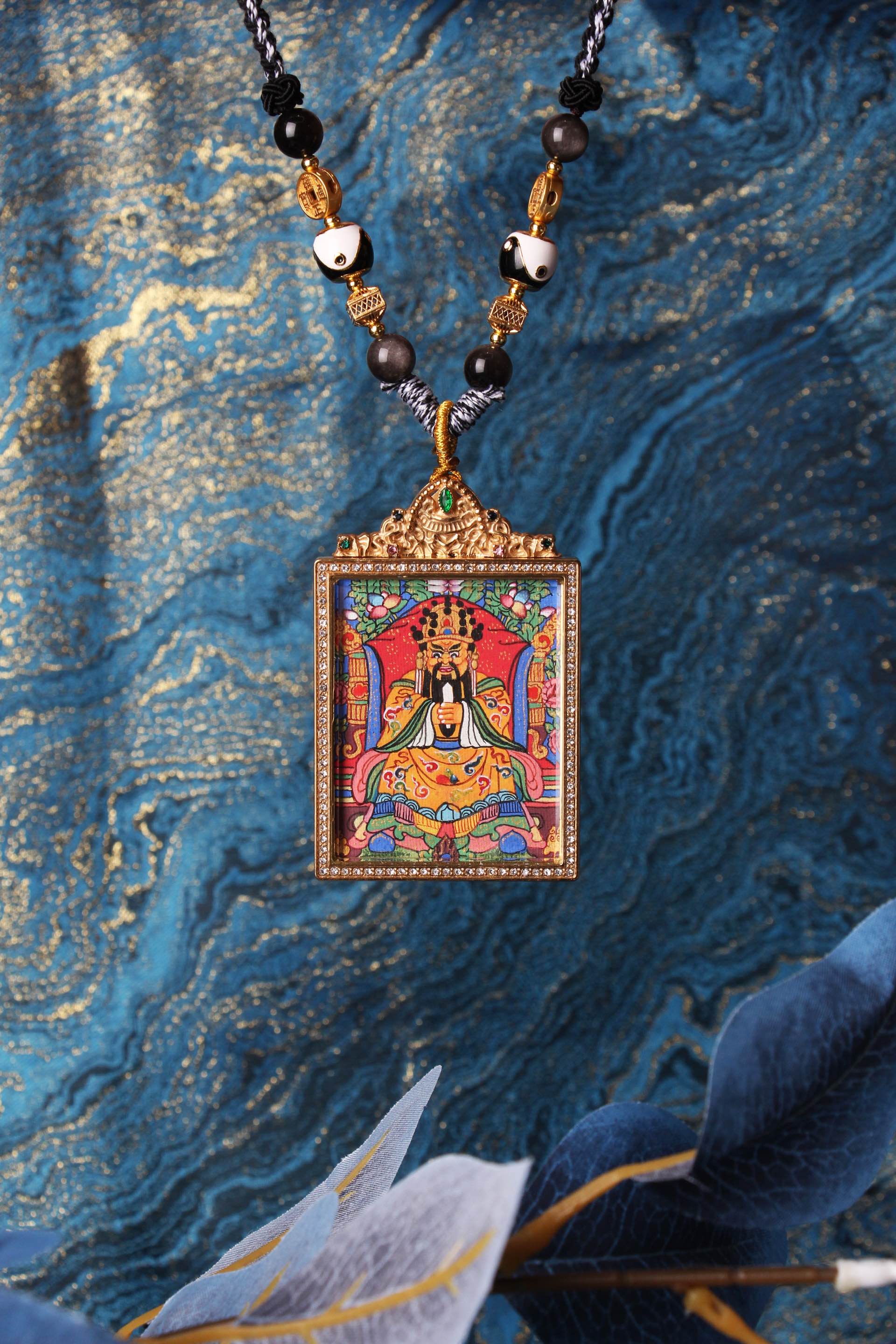 Close-up of Dragon Fifth Lord Wu Ye thangka pendant with gemstone metal frame, representing wealth protection, moral prosperity, and auspicious blessings