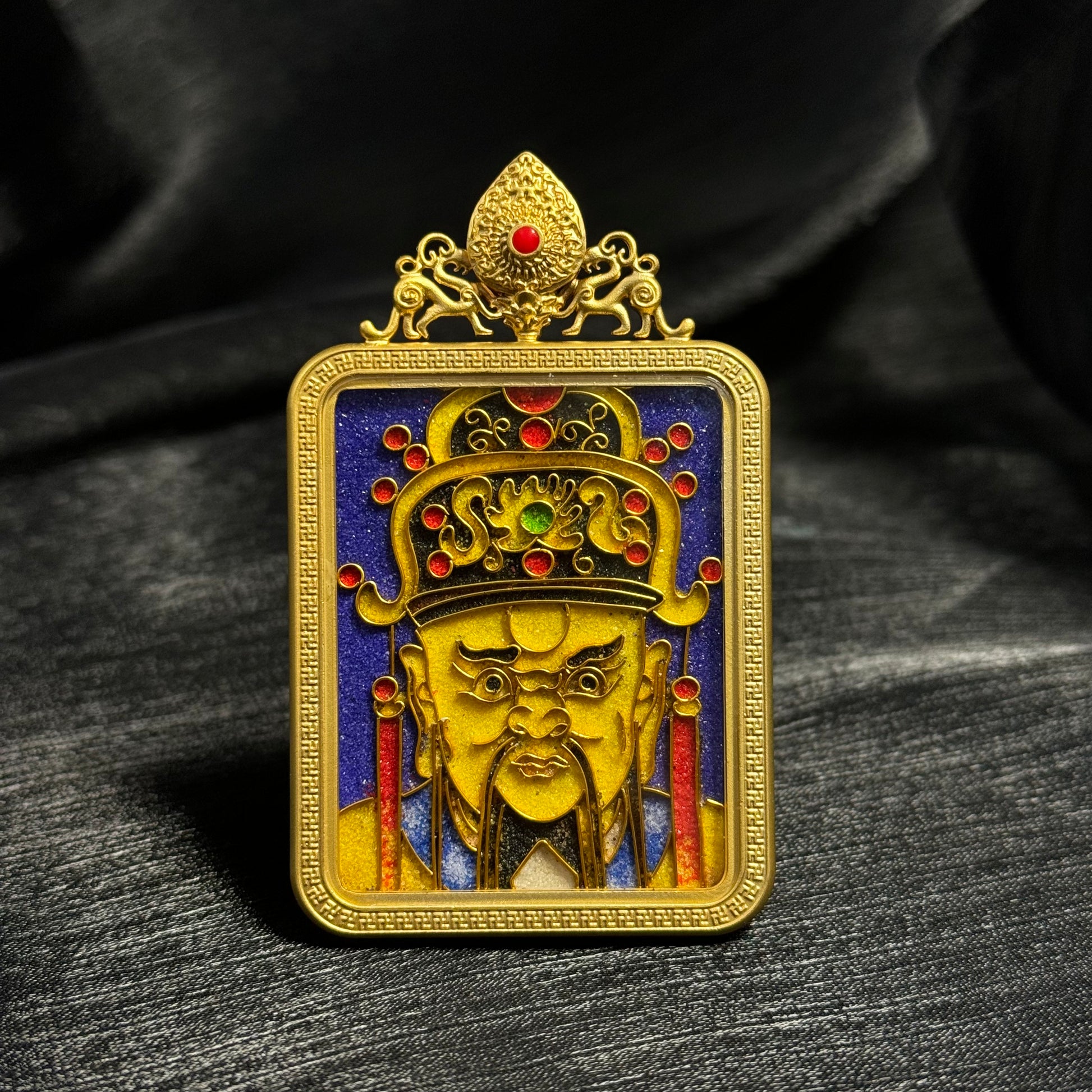 Handcrafted cloisonné enamel Dragon King Wuye mini thangka pendant with 24K gold-plated copper frame, detailed golden deity face, ornate crown with red enamel accents, and deep blue enamel background.