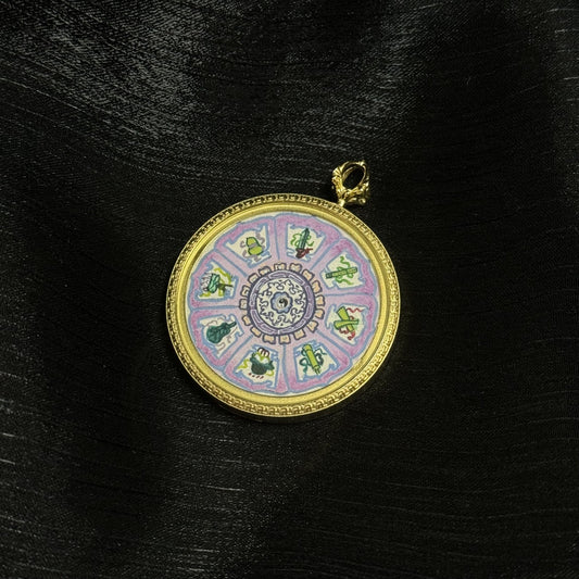 Front view of an Eight Immortals instruments Bagua mini thangka pendant showing a circular wheel layout with eight symbolic emblems around a central medallion, set in a gold-tone round frame.