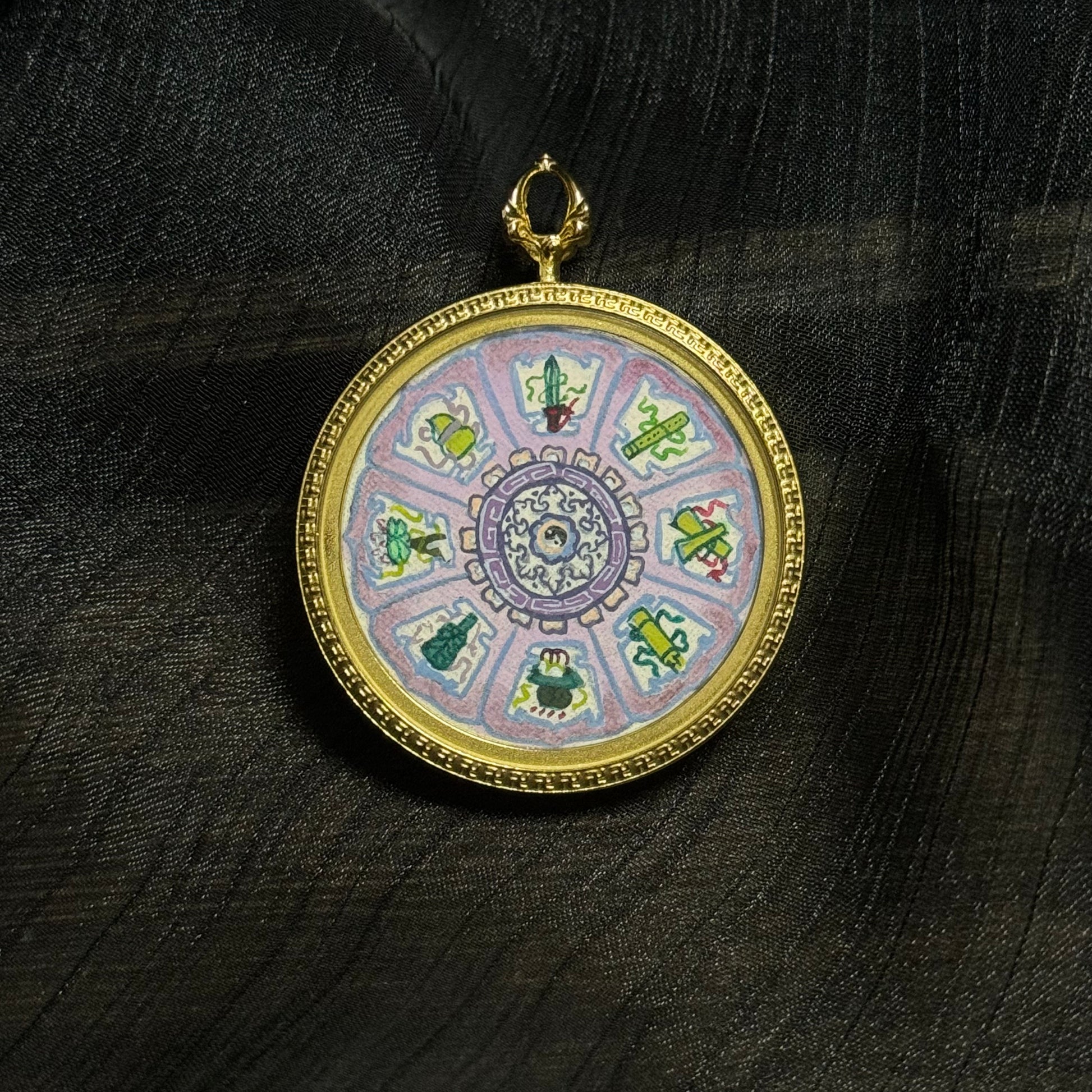Hand-painted miniature thangka pendant showing the symbolic objects of the Eight Immortals including sword, gourd, fan, flute, flower basket, lotus, fish drum, and jade tablet.