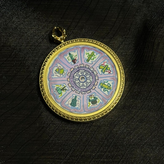 Mini thangka pendant featuring the Eight Immortals sacred symbols arranged in a circular mandala design, hand-painted with colorful mineral pigments and set in a gold-toned pendant frame.