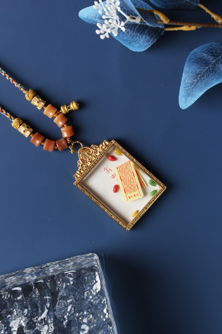 Interior view of a double-sided Tibetan thangka pendant featuring five-color rice and a protective blessing amulet, enclosed in a jewelry-grade titanium steel case for durability and spiritual preservation.