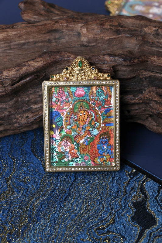 Close-up front view of Five Wealth Deities mini thangka pendant, hand-painted with mineral pigments in a jeweled double-sided titanium steel case, Nepal series