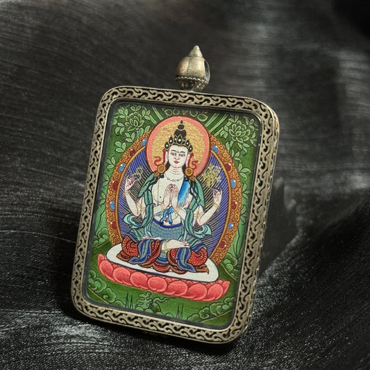 Close-up detail of a Four-Armed Avalokiteshvara mini thangka showing calm expression, precise iconography, refined line work, and layered natural mineral pigments in Rebgong traditional style