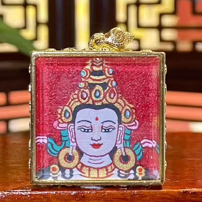 Hand-painted Four-Armed Avalokiteshvara mini thangka pendant in a gilded copper Ghau box, front view