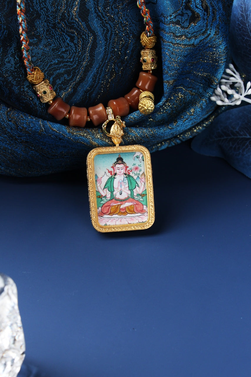Front view of Four-Armed Avalokiteshvara mini thangka pendant highlighting the hand-painted figure, cloud base elements, textured rectangular bezel, and metal pendant edging