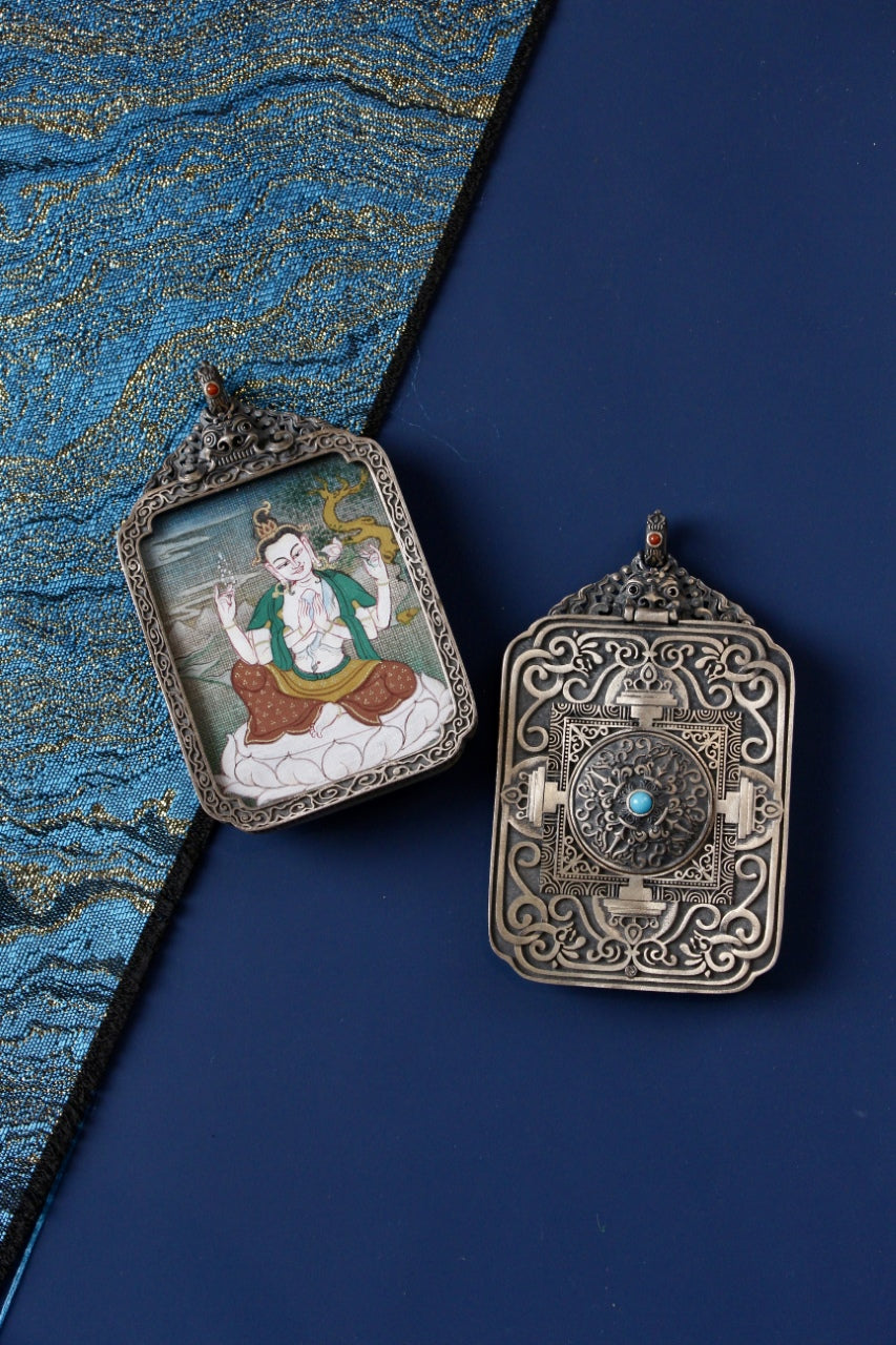 Front and back view of Four-Armed Avalokiteshvara mini thangka pendant, hand-painted with mineral pigments and set in a vintage silver case, Tibetan origin