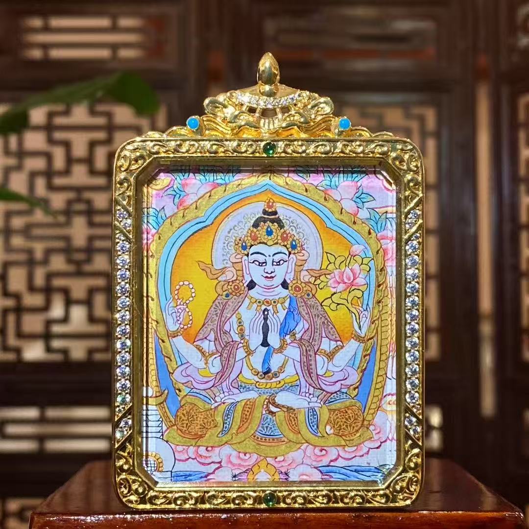 Hand-painted Four-Armed Avalokiteshvara thangka pendant with soft color palette in a gilded copper Ghau box, front view