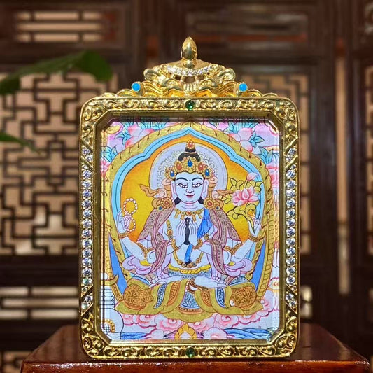 Hand-painted Four-Armed Avalokiteshvara thangka pendant with soft color palette in a gilded copper Ghau box, front view