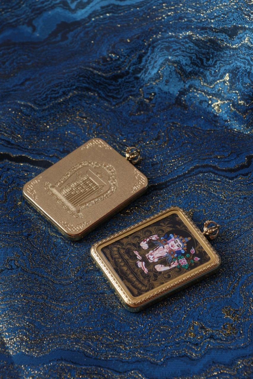 Back view of Four-Armed Avalokiteshvara mini thangka pendant showing engraved back plate and titanium steel casing, compact and durable design for daily spiritual wear.