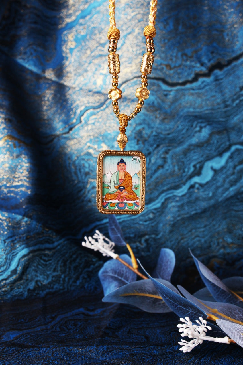 Front view of Amitabha Buddha mini thangka pendant focusing on the pendant connector, knotwork, and metal bead components above the rectangular frame