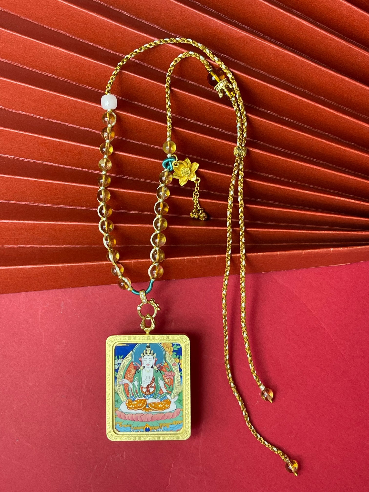 Full necklace view of Mahasthamaprapta Bodhisattva mini thangka pendant with Tibetan mineral pigment painting, copper frame, and yellow crystal woven cord