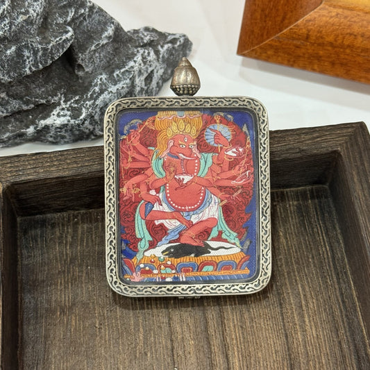 Close-up front view of Ganapati (Vinayaka) pendant featuring ornate silver border, detailed hand-painted multi-armed elephant-headed deity, and layered red background patterns.