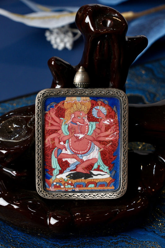 Ganesha mini thangka pendant displayed for devotional and collectible purposes, emphasizing Tibetan iconography of an elephant-headed protector deity