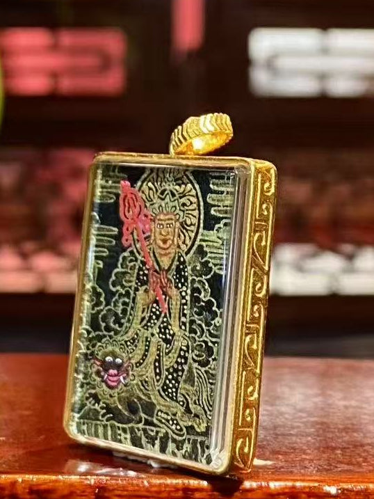 Side view of an 18K gold Gau box Black Gold Thangka pendant showing the hollow double-sided structure and sapphire crystal protective cover