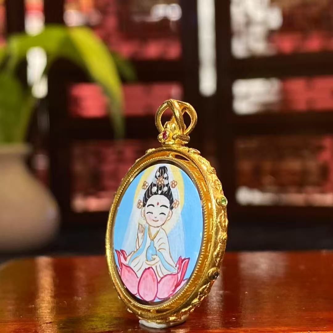 Side view of an 18K gold Gau box Thangka pendant showing the hollow reversible structure and sapphire crystal protective cover