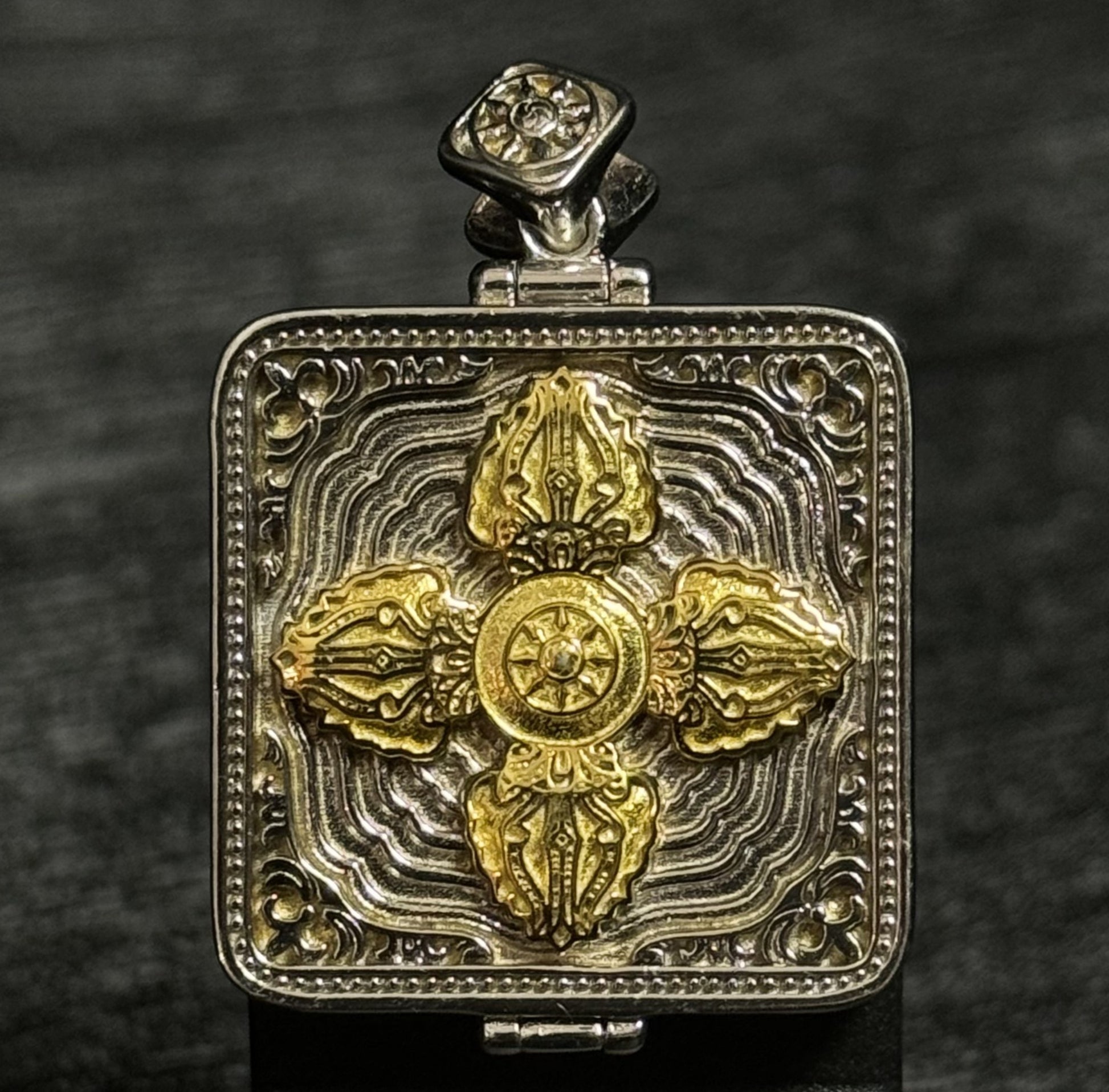 Back view of Tibetan gawu pendant featuring engraved double vajra symbol used for portable Buddhist shrine pendants