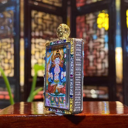 Side view of Four-Armed Avalokiteshvara mini thangka pendant showing gilded copper Ghau box craftsmanship