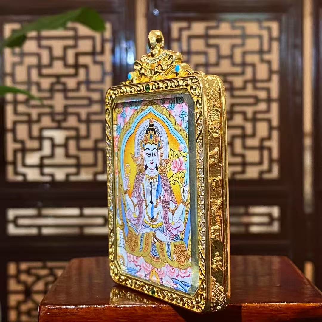 Side view of soft-toned double-sided Four-Armed Avalokiteshvara thangka pendant showing gilded copper Ghau box details