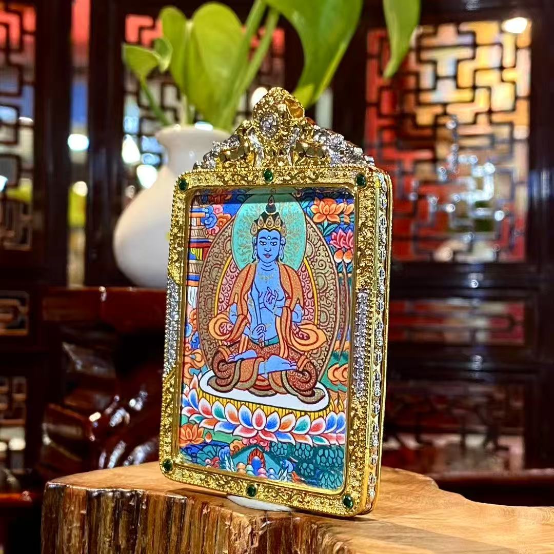 Side view of gold-plated copper gau pendant housing a hand-painted Akashagarbha Bodhisattva thangka