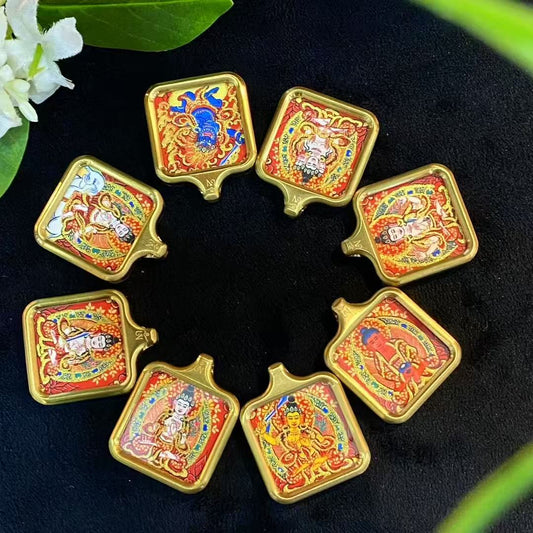 Close-up of gold line detailing on hand-painted miniature Tibetan thangka pendant for wholesale production