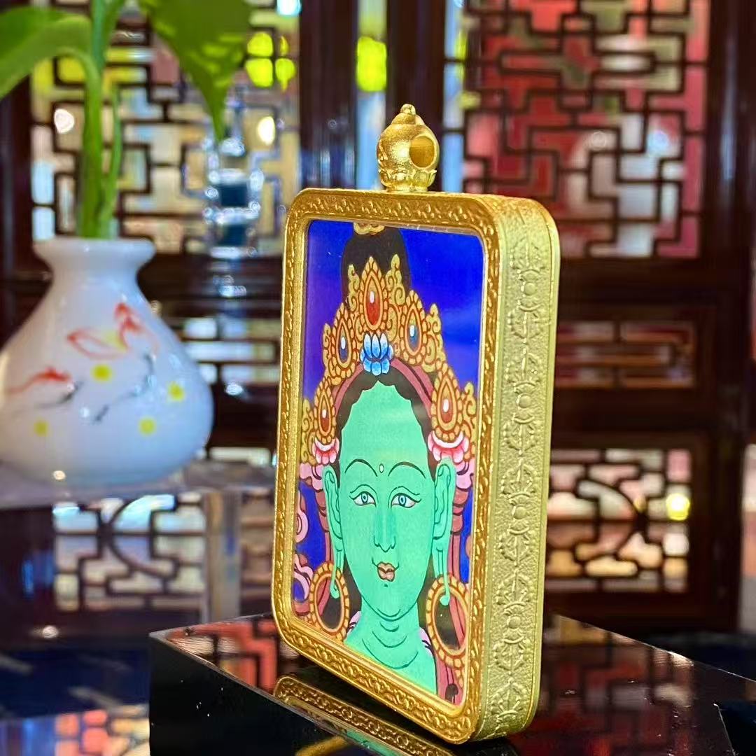 Side view of a Green Tara Gau Thangka pendant showing the thickness, gold-plated copper frame, and fine craftsmanship of the portable gau box