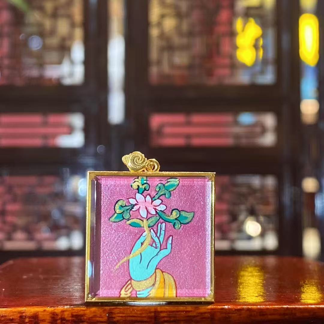 Back view of a hand-painted Green Tara Gau Thangka pendant featuring the sacred Utpala flower, symbolizing fulfillment, wisdom, and transformation