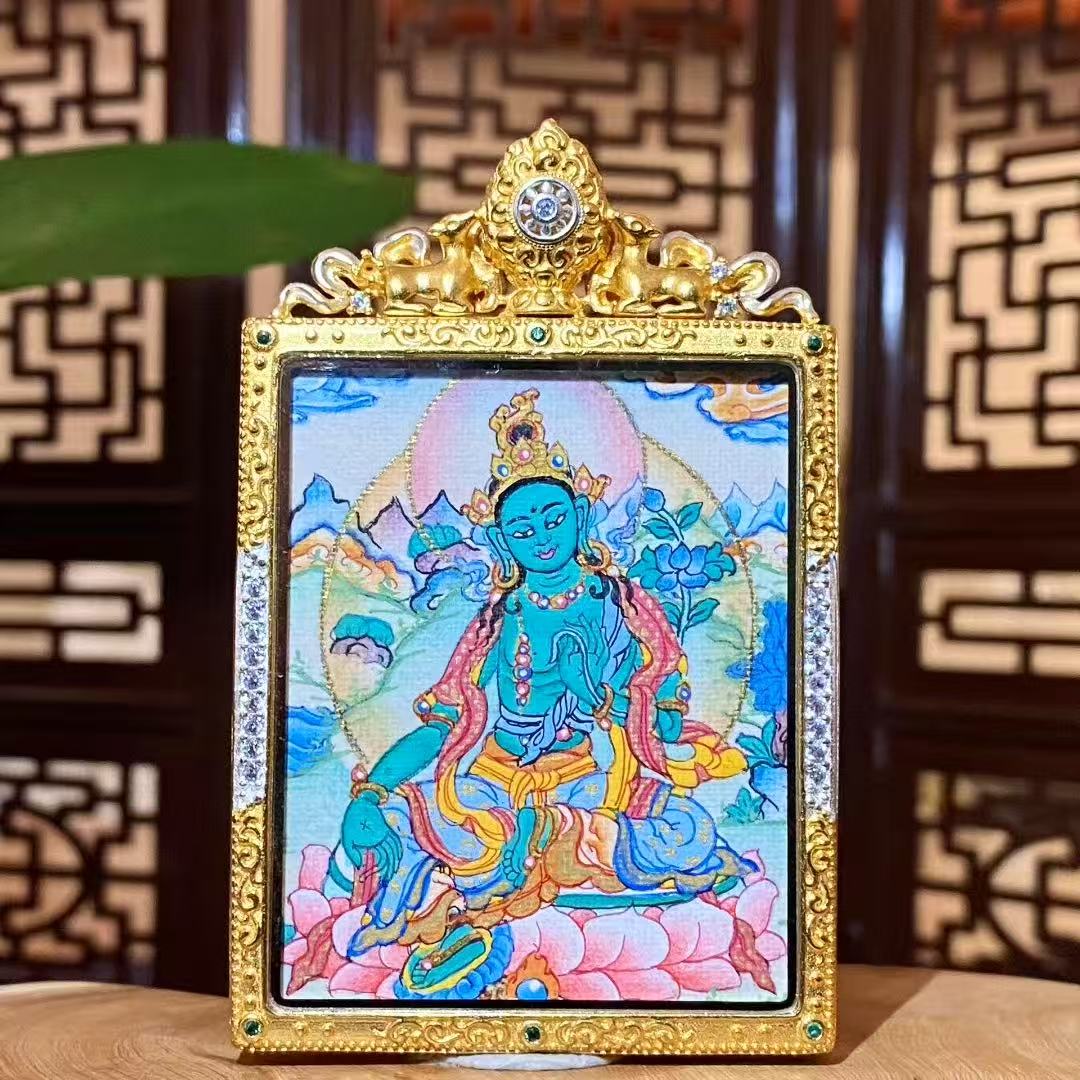 Front view of a hand-painted Green Tara Gau Thangka pendant featuring the compassionate Green Tara seated on a lotus, set in a gold-plated copper box