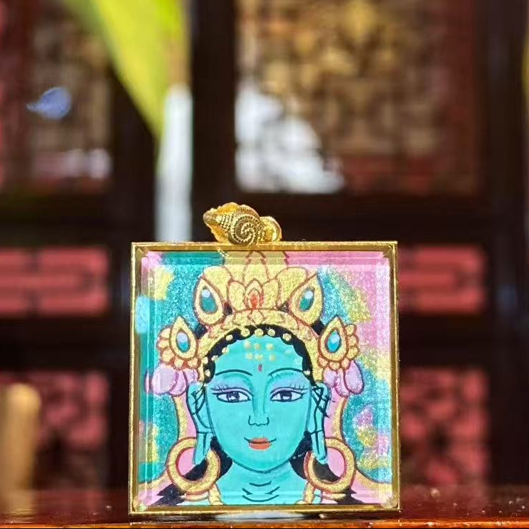 Front view of a hand-painted Green Tara Gau Thangka pendant in an 18K gold case, showing the serene Green Tara with a gentle and compassionate expression