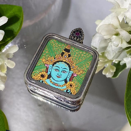 Front view of a hand-painted Green Tara thangka pendant in an S925 silver Ghau box, 29 mm diameter