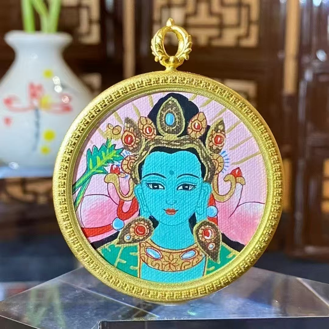 Front view of a hand-painted Green Tara thangka pendant in a round copper Ghau box, 42 mm diameter