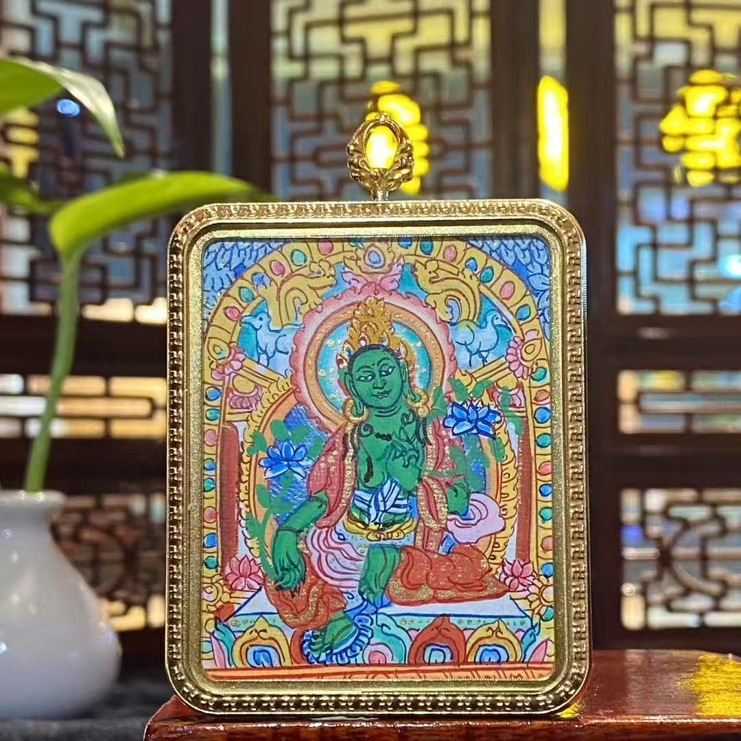 Front view of a hand-painted Green Tara thangka pendant in a titanium steel Ghau box, size 56 × 46 mm