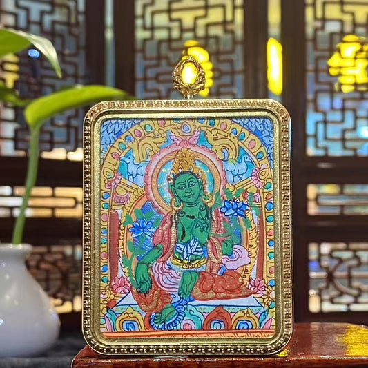 Front view of a hand-painted Green Tara thangka pendant in a titanium steel Ghau box, size 56 × 46 mm