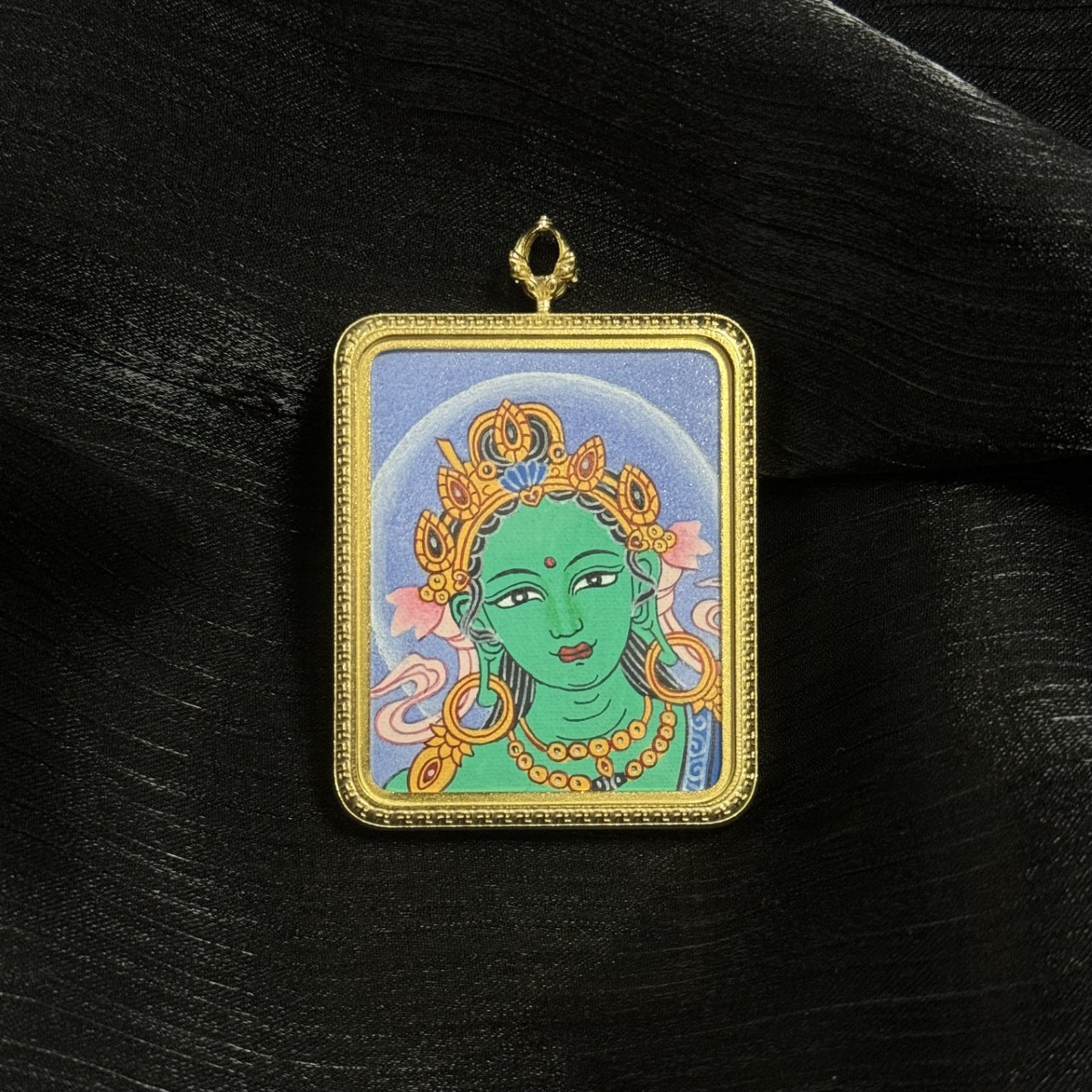 Hand-painted Green Tara head miniature thangka pendant in a gold-tone titanium steel frame, featuring traditional Nepal mineral pigment painting and detailed Tara crown ornaments.
