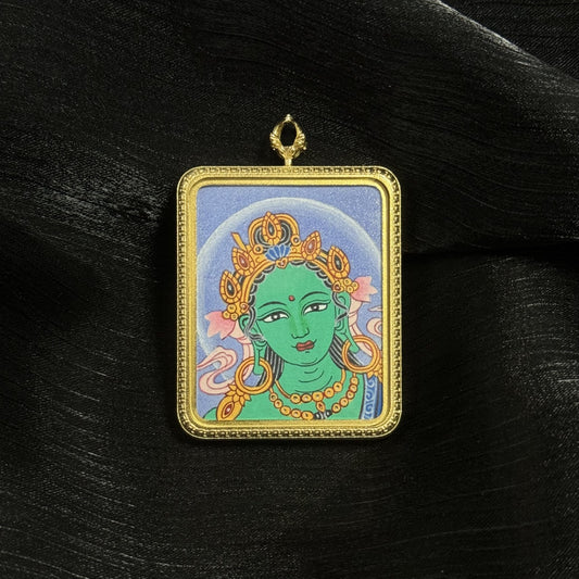 Hand-painted Green Tara head miniature thangka pendant in a gold-tone titanium steel frame, featuring traditional Nepal mineral pigment painting and detailed Tara crown ornaments.