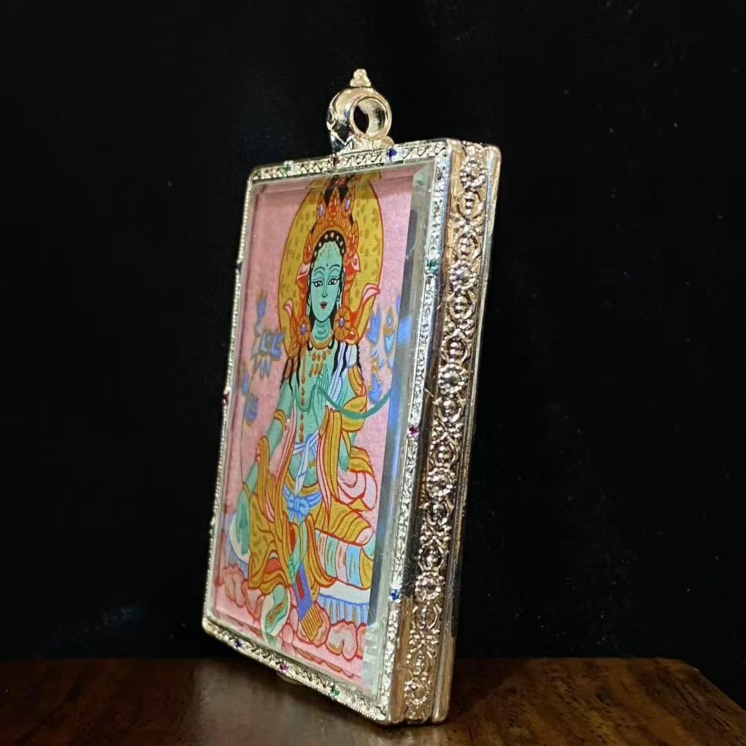 Side view of a large Green Tara Gau Thangka pendant showing the copper frame, substantial thickness, and devotional-grade craftsmanship